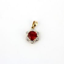 A hallmarked 9ct yellow gold cluster pendant set with a round cut red stone and small diamonds, L.