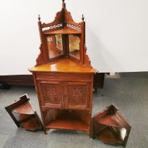 A carved mahogany mirror backed corner cabinet, together with a pair of mahogany mirror backed