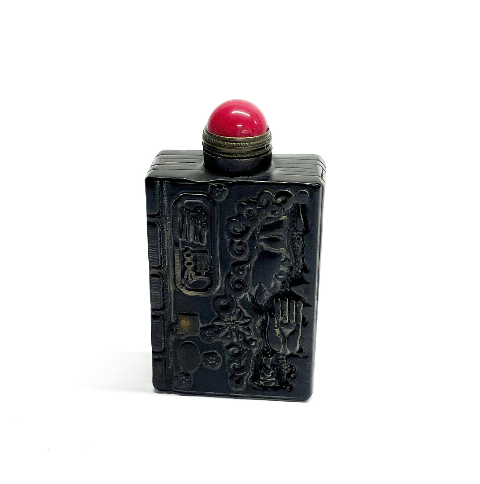 A Chinese carved horn snuff bottle with polished hardstone stopper, H. 7.5cm.