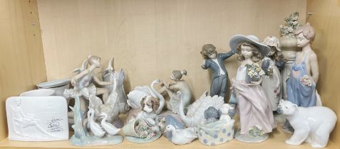 A large collection of Lladro, Nao and other porcelain figures, tallest H. 30cm.
