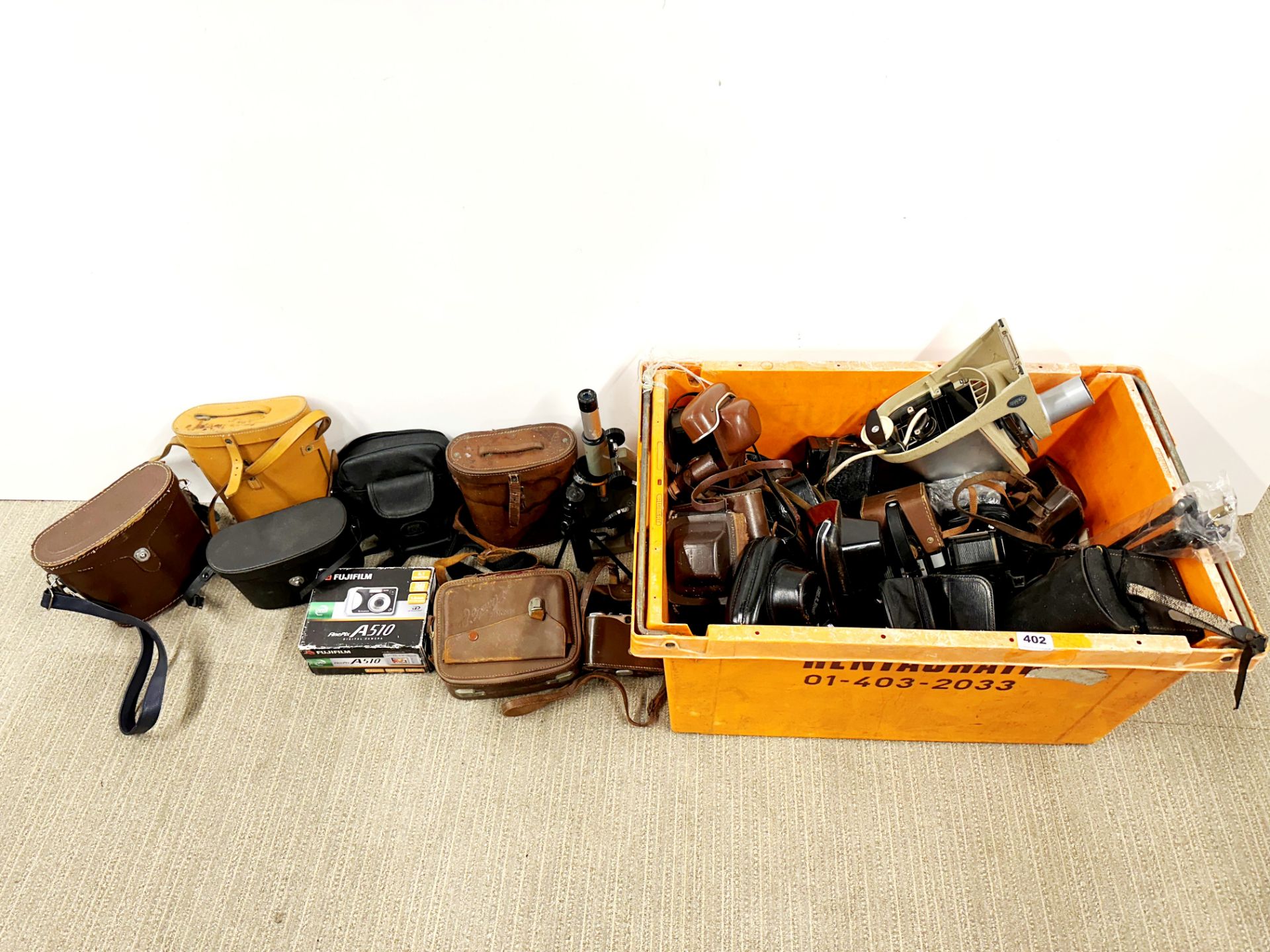 A large box of mixed cameras, binoculars, etc.