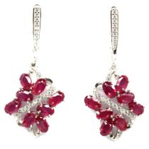 A pair of 925 silver drop earrings set with oval cut rubies and white stones, L. 3cm.