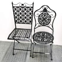 A folding cast iron garden chair with a further cast metal folding garden chair.