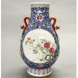 A finely decorated mid 20th C Chinese enamelled porcelain vase, previously drilled as a lamp base