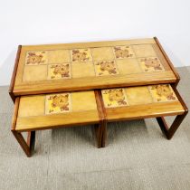 A 1970's teak nest of tile topped tables, largest 104 x 40 x 46cm.