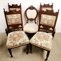 A set of four carved oak and floral upholstered dining chairs and one further dining chair.
