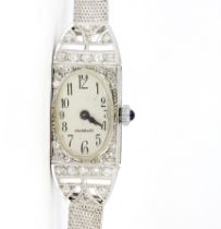 A French 18ct white gold diamond set cocktail watch (French eagles head hallmark), L. 17cm.
