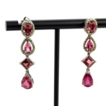 A pair of handmade white metal (tested silver) drop earrings set with diamonds and tourmalines, L.