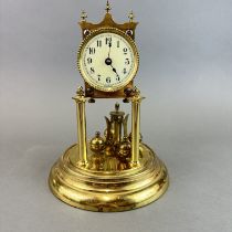 A torsion gilt brass clock under dome, H. 28cm.