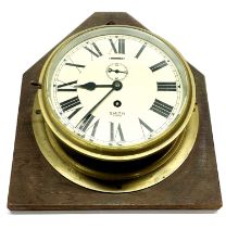 An oak mounted brass Smith Astral ship's style wall clock, H. 39cm.