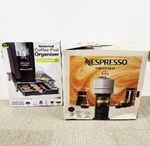 An unused boxed Nespresso machine with coffee pod organised.
