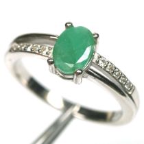 A 925 silver ring set with an oval cut emerald and white stones, (N).