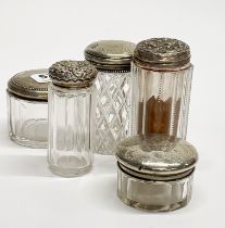 A group of silver topped dressing table bottles, tallest H. 11cm.