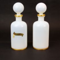 A pair of Venetian gilt mounted opaline glass dressing table bottles, H. 21cm.