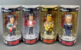 A set of four sealed 2002 Licks world tour bobble head figures.