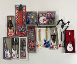 A quantity of miniature guitars and drumkits.