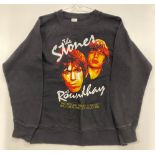 Three small women's Rolling Stones commemorative t-shirts with varying designs.