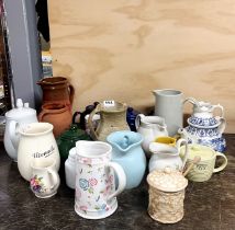 A group of ceramic jugs and teapots.
