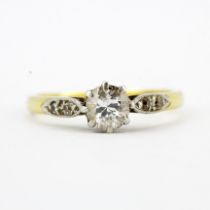 An 18ct gold and platinum ring set a large brilliant cut diamonds and diamond set shoulders,