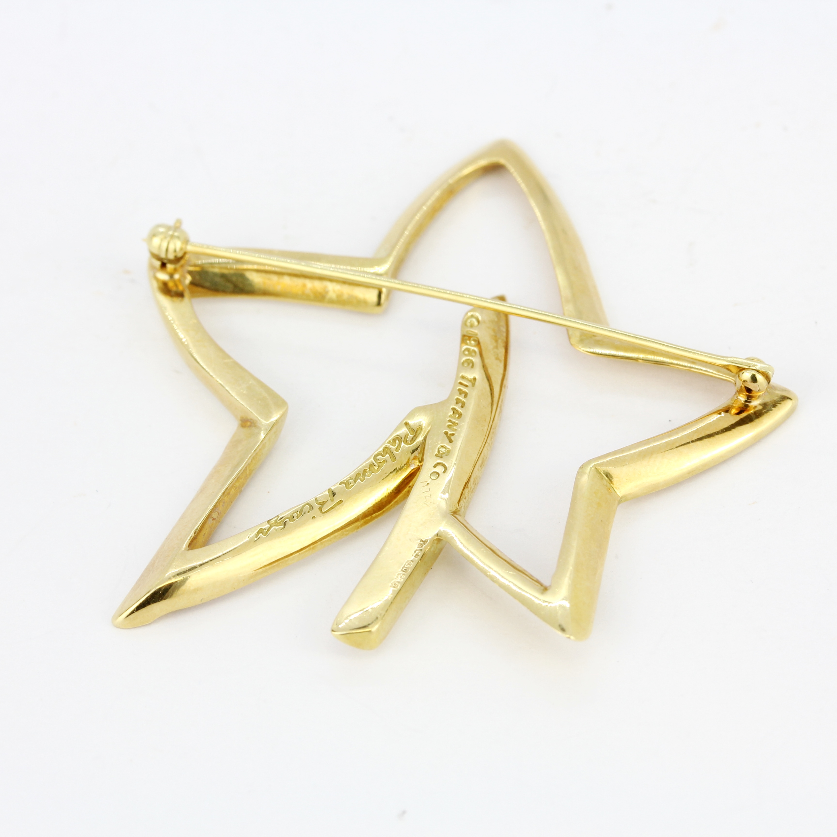 An 18ct yellow gold Tiffany & Co star shaped brooch, L. 5.2cm. - Image 2 of 3