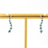 A pair of 9ct white gold drop earrings set with round cut blue topaz and diamonds, L. 2cm.
