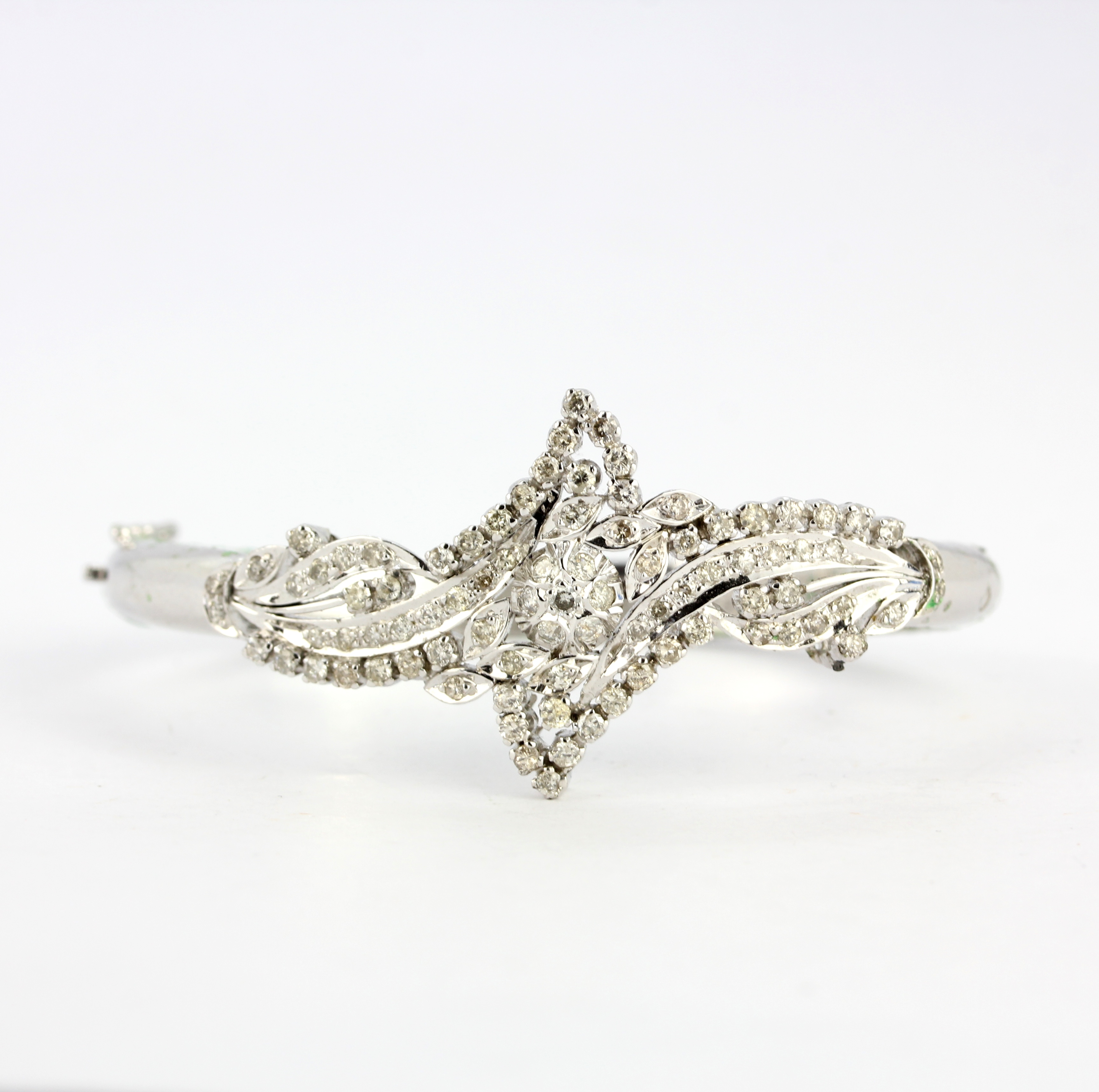 A white gold plated base metal bangle lavishly set with diamonds (ideal for break up), diamond