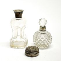 A hallmarked silver rimmed perfume bottle with a gilt lined white metal pill box and a further