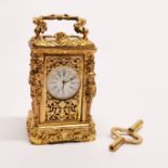 A miniature gilt brass carriage clock, H. 9cm.