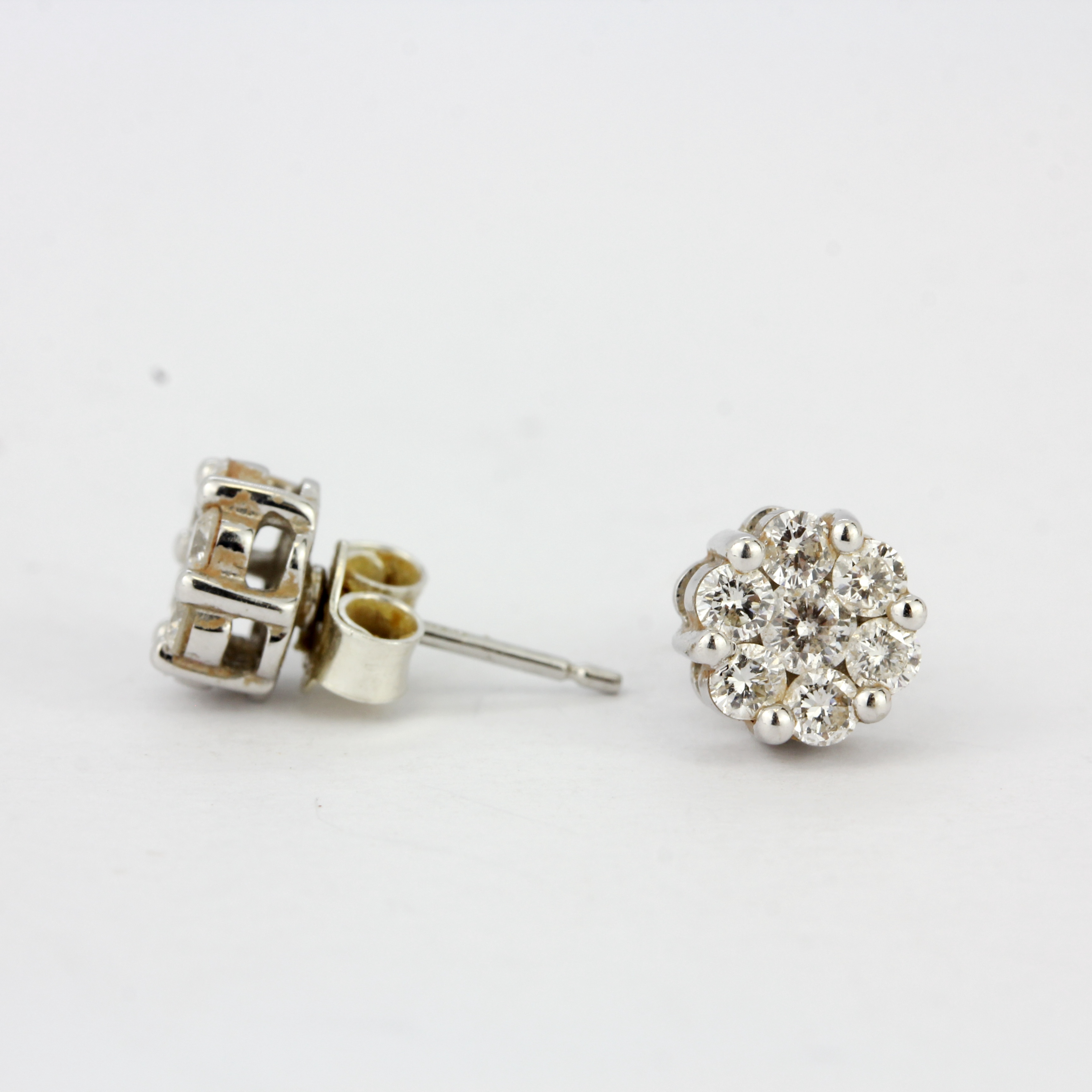 A pair of hallmarked 9ct white gold diamond set stud earrings, L. 6mm. One with replacement back. - Image 3 of 3