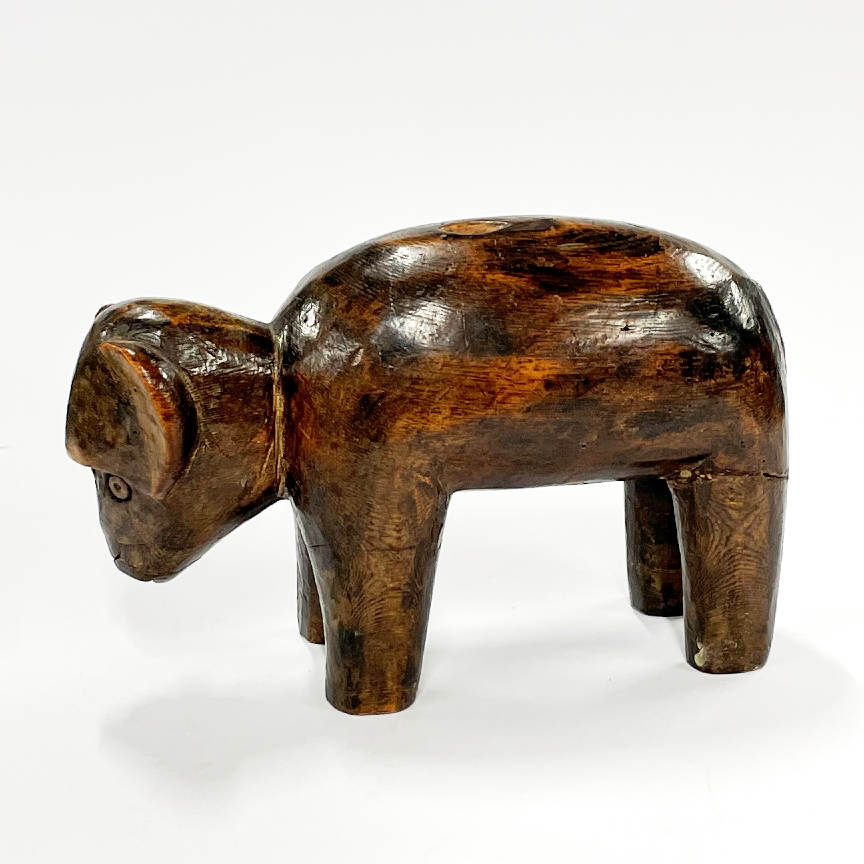 A 19th / early 20th century African tribal carved wooden bull figure, L. 18cm, H. 12cm. Some