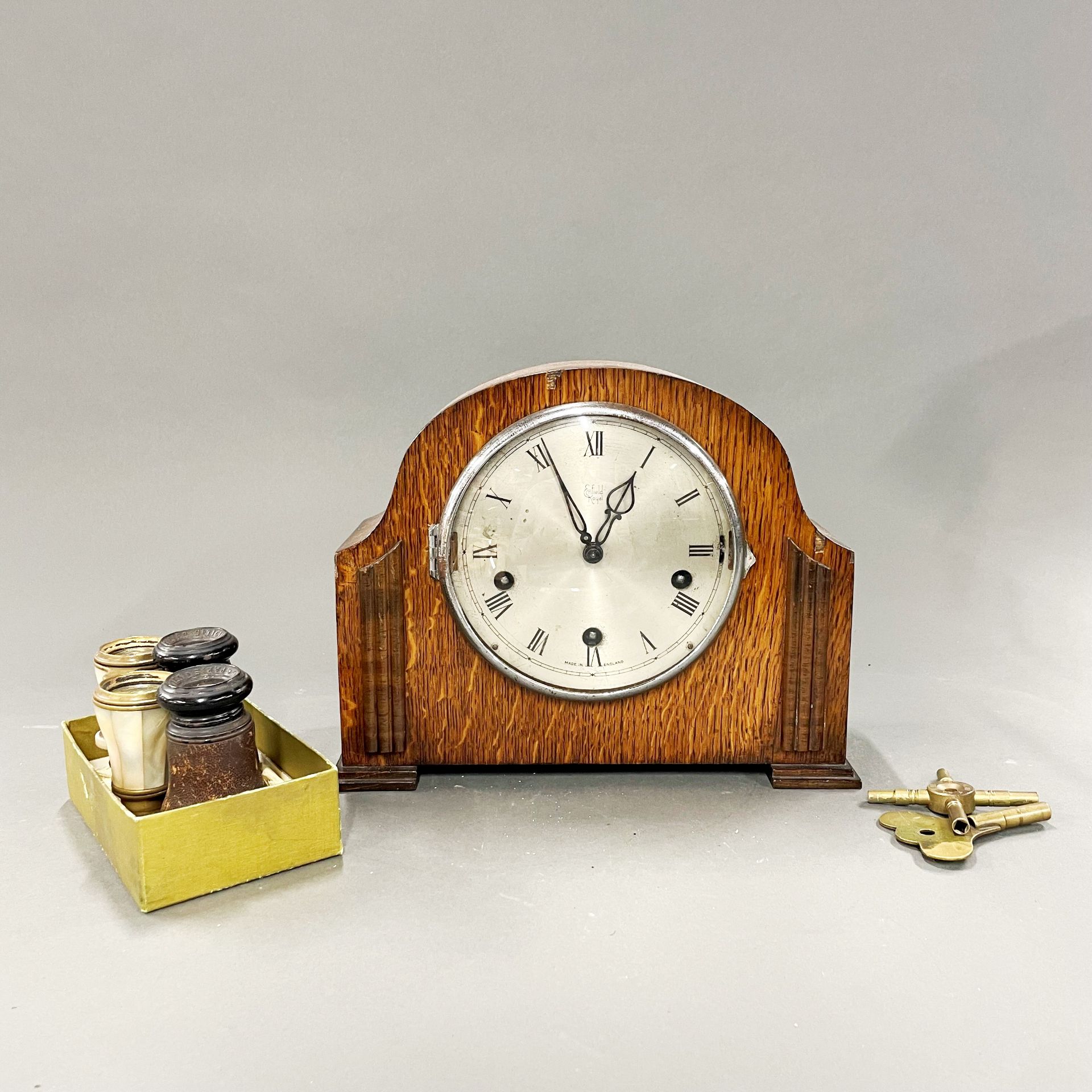 A 1930's chiming oak mantle clock, together with two pairs of opera glasses.