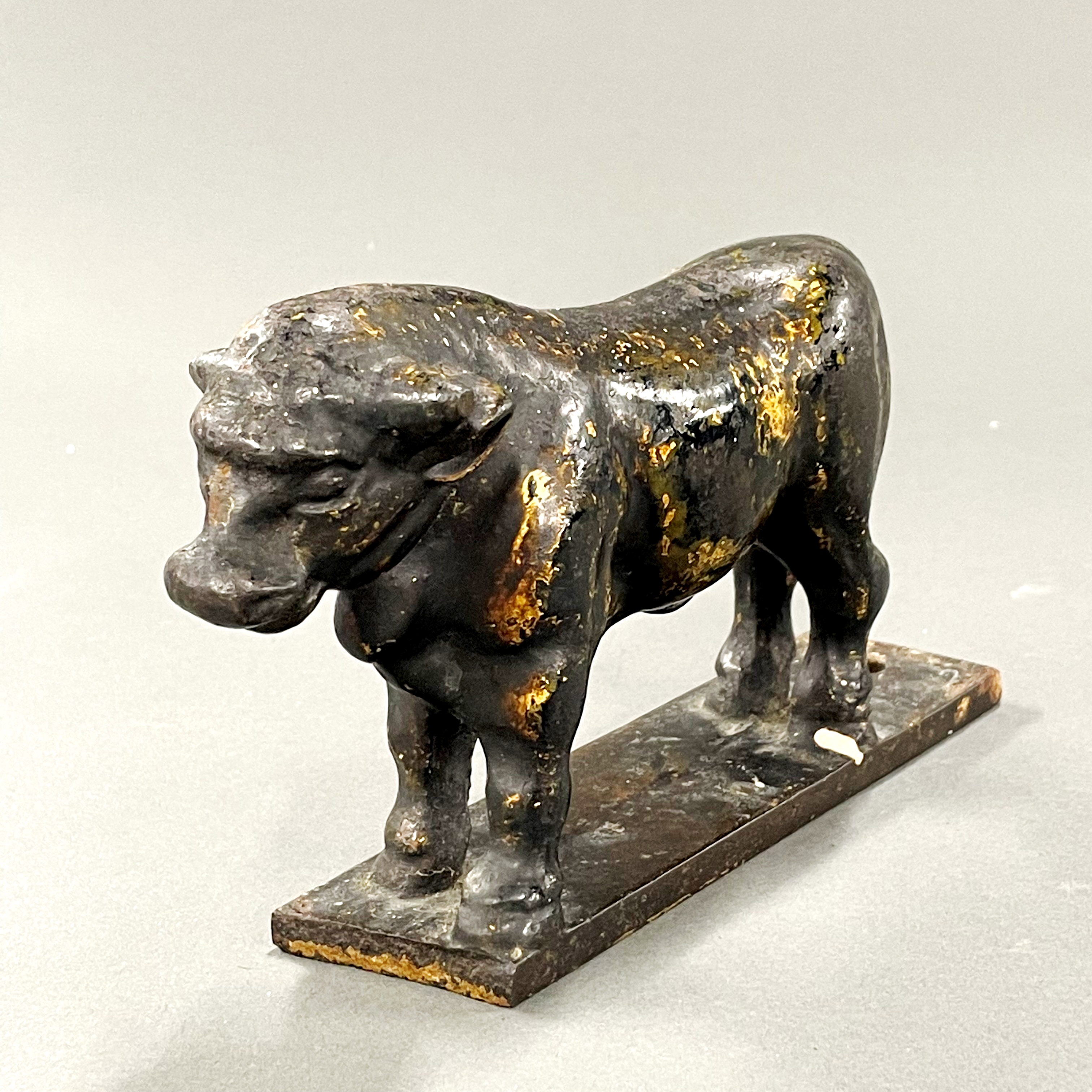 A 19th century cast bronze butchers shop window bull, L. 17cm, H. 10cm.