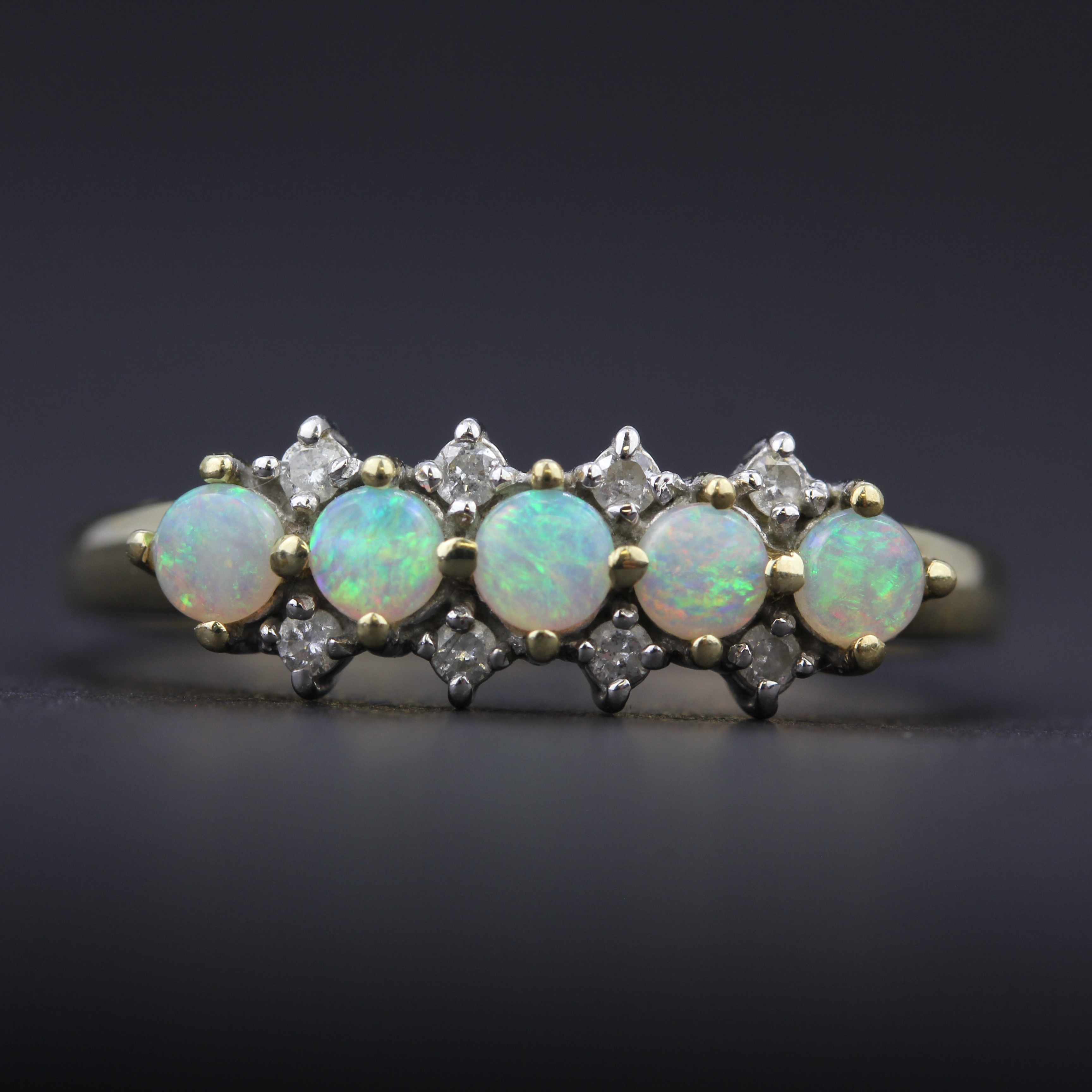 A 9ct yellow gold ring set with brilliant cut diamonds and cabochon cut opals, (R.5) - Image 2 of 3