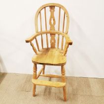 A light oak spindle back child's high chair, H. 96cm.