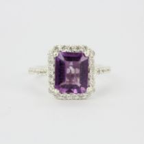 A 925 silver ring set with an emerald cut amethyst and white stones, (P).