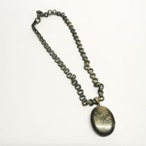 A Victorian white metal locket and chain, L. 48cm.