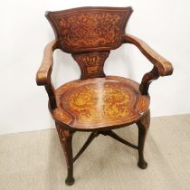 An early 20thC intricately decorated and inlaid mahogany elbow chair, H. 83cm.