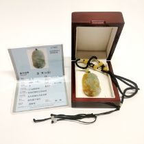 A lovely Chinese carved jade amulet, L. 5cm, with certificate.