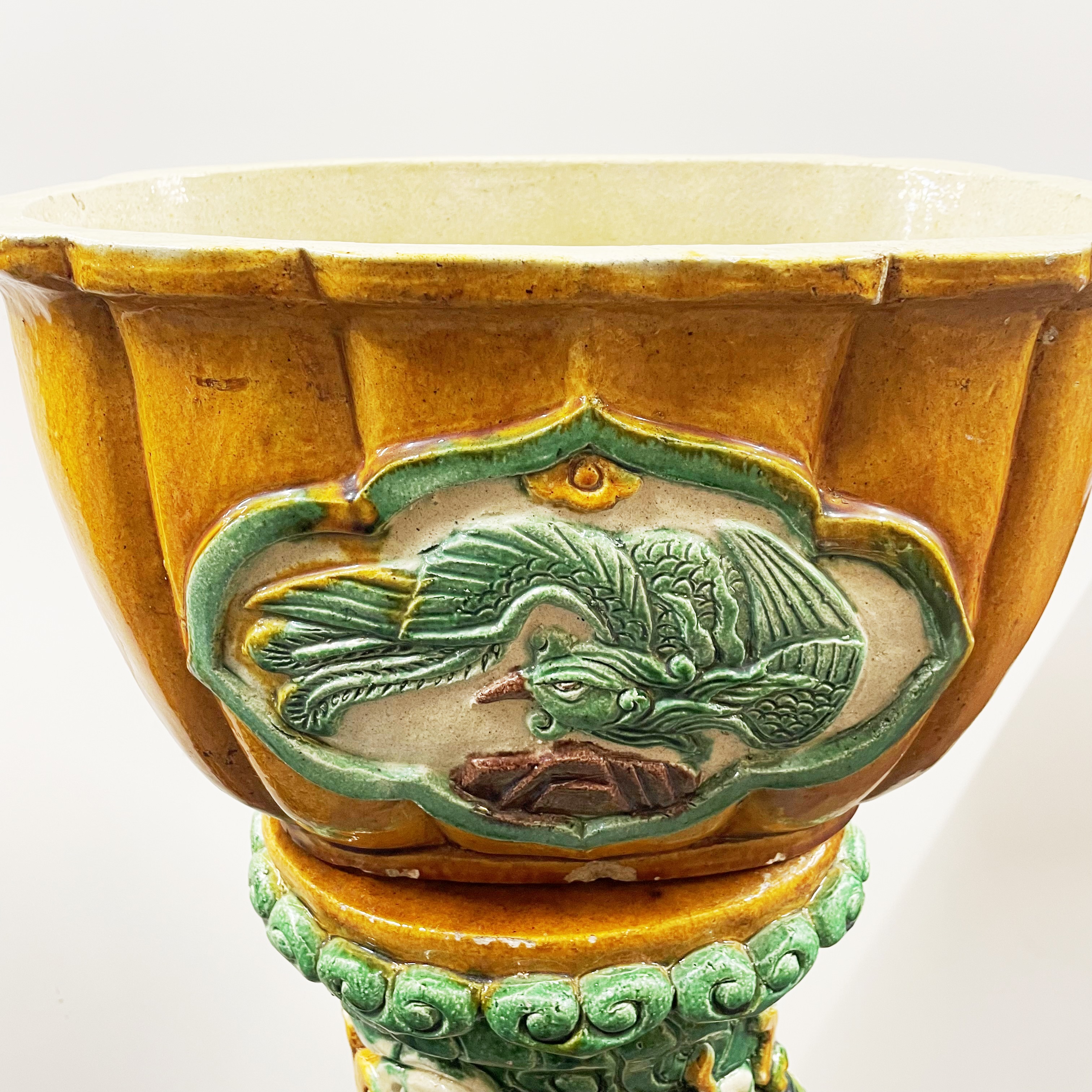 An impressive pair of large Chinese glazed terracotta planters on stands, relief decorated with - Image 3 of 7