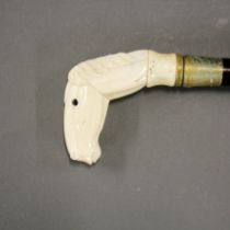 A carved bone horses head handle walking stick, cane L. 92cm, horses head L. 9cm.