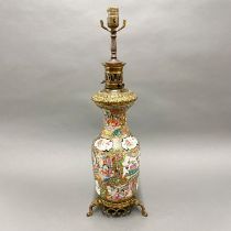 A 19thC Chinese famille rose porcelain vase, mounted c. 1900 as a table lamp. (A/F), H. 67cm.
