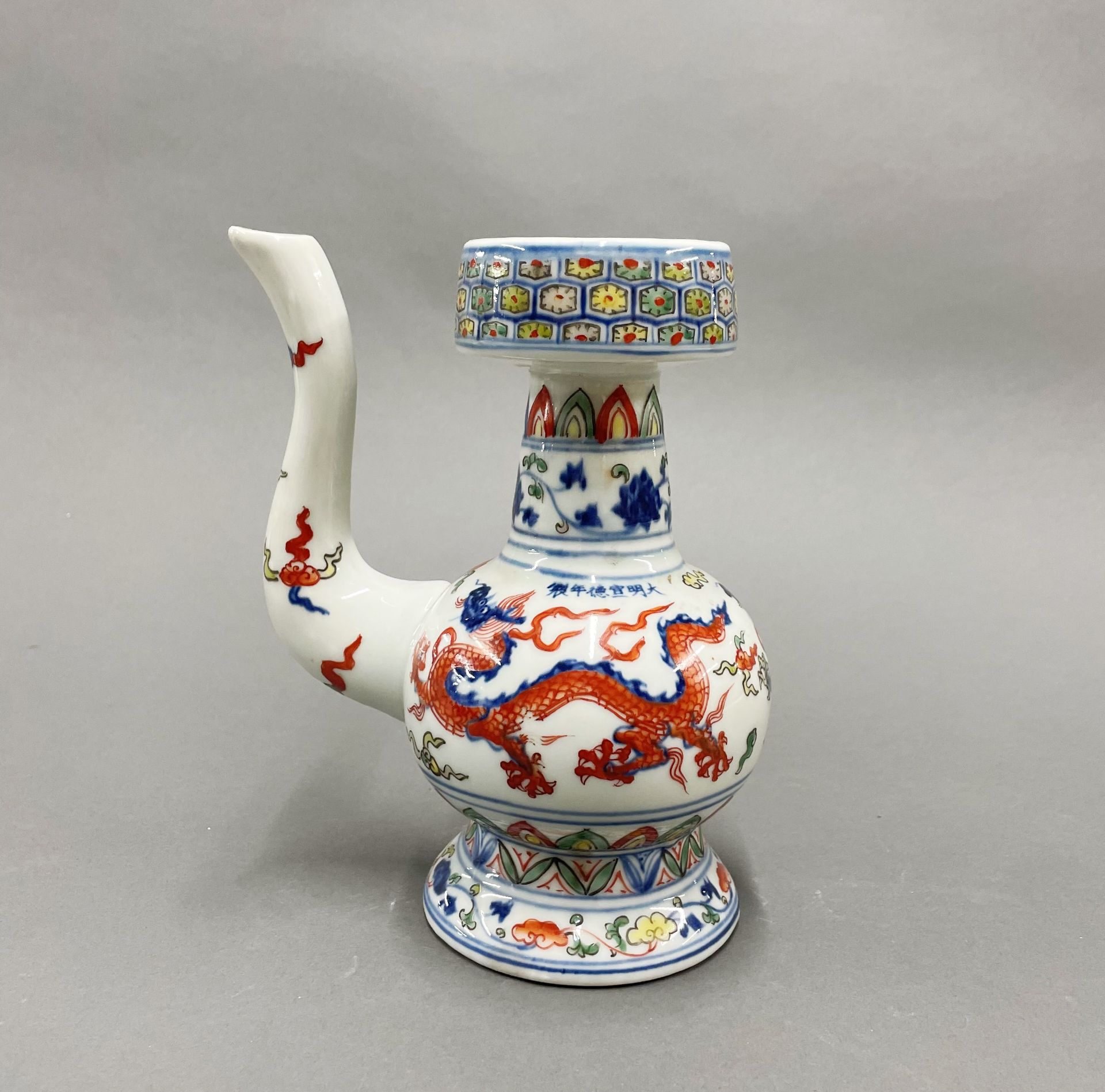 An unusual hand painted porcelain oil pourer, H. 20cm.