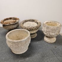 Three antique concrete planters together with an antique carved sandstone planter, largest 58 x