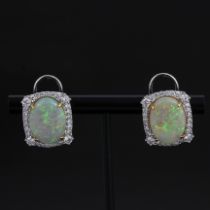 A large pair of white metal (tested high carat gold) earrings set with large oval cut opals