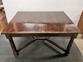 An oak extending dining table together with a set of six triple panel backed oak dining chairs