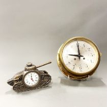 A gilt brass ship's style clock, dia. 18cm, together with a WWI tank shaped clock, L. 15cm.