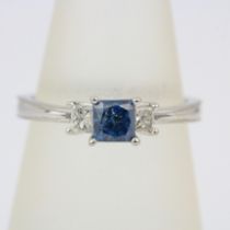 A 14ct white gold ring set with a princess cut fancy blue diamond and princess cut diamond set