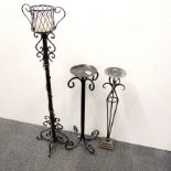 Three wrought iron candle stands, tallest H. 84cm.