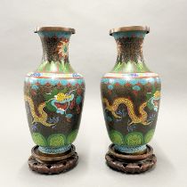 A pair of large mid 20thC Chinese cloisonne vases on carved hardwood stands, H. (with stand) 37cm.