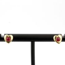 A pair of 9ct yellow gold heart shaped ruby set stud earrings, L. 5mm.